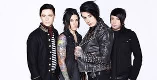 Four band members in dark clothing posing together against a white background